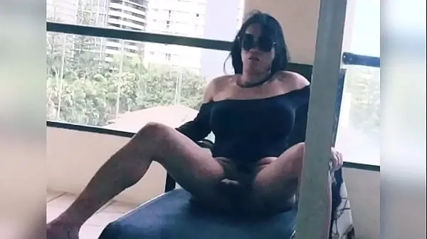 XXX tranny stroking her big cock in her hotel balcony ống lớn
