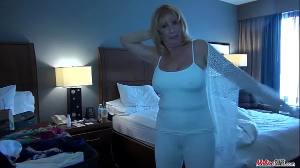 XXX Busty mature puts on some clothes after posing nude mega Tube